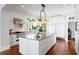 Kitchen features island, tile backsplash, and stainless steel appliances at 72 Adalia Ave, Tampa, FL 33606