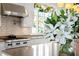 Bright kitchen featuring white cabinets and a large window at 72 Adalia Ave, Tampa, FL 33606