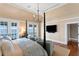 Serene main bedroom with waterfront views, neutral tones, and access to a private balcony at 72 Adalia Ave, Tampa, FL 33606