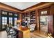 Spacious home office with custom wood shelving, a large desk, and views of the water at 72 Adalia Ave, Tampa, FL 33606