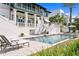 Exterior view of backyard with a beautiful pool and patio at this luxurious multi-story house at 72 Adalia Ave, Tampa, FL 33606