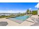 Backyard view featuring an in-ground swimming pool, boat dock, waterfront and lounge chairs at 72 Adalia Ave, Tampa, FL 33606