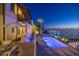 Luxury waterfront home featuring a stunning pool, dock access, and city views on a beautifully landscaped property at 72 Adalia Ave, Tampa, FL 33606