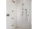 Luxurious walk-in shower with multiple shower heads, handheld fixture, and white tiled walls at 72 Adalia Ave, Tampa, FL 33606