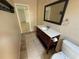 Hall bathroom with a marble vanity, tiled shower and walls, and a neutral color scheme at 7425 Riverbank Dr, New Port Richey, FL 34655