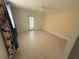 Spacious bedroom with tile flooring, neutral walls, ceiling fan, and access to the backyard through a sliding glass door at 7425 Riverbank Dr, New Port Richey, FL 34655