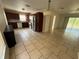 Open kitchen with dark wood cabinets, stainless steel appliances, tile flooring, connecting to the rest of the home at 7425 Riverbank Dr, New Port Richey, FL 34655