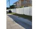 A view of the side yard and white vinyl fence at 8461 5Th N St, St Petersburg, FL 33702