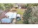 Aerial view of a backyard with a workshop and watercraft storage at 8523 Hamster Dr, Zephyrhills, FL 33540