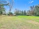Backyard featuring a large grassy area that is fully fenced at 8523 Hamster Dr, Zephyrhills, FL 33540
