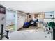 View of a basement with an open door, equipment, and decorations on the walls at 8523 Hamster Dr, Zephyrhills, FL 33540