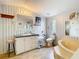 Bathroom featuring a step-up tub, toilet, and sink with vintage striped wallpaper and a laminate floor at 8523 Hamster Dr, Zephyrhills, FL 33540