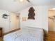 Bedroom features light wood floors, white walls, and a light colored bedspread at 8523 Hamster Dr, Zephyrhills, FL 33540