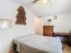 Bedroom features light wood floors, white walls, and a light colored bedspread at 8523 Hamster Dr, Zephyrhills, FL 33540