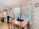 Dining room with a wooden table and chair set below a decorative window at 8523 Hamster Dr, Zephyrhills, FL 33540