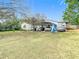 View of the house featuring a large metal carport with cars at 8523 Hamster Dr, Zephyrhills, FL 33540