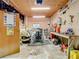 View of a cluttered garage featuring a workbench with multiple tools and supplies at 8523 Hamster Dr, Zephyrhills, FL 33540