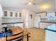 Eat-in kitchen with white cabinets, black countertops, and floral wallpaper at 8523 Hamster Dr, Zephyrhills, FL 33540