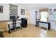 Living room featuring light wood flooring and vintage wallpaper borders at 8523 Hamster Dr, Zephyrhills, FL 33540
