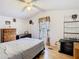View of the bright main bedroom featuring a window, decor, dresser, and side table at 8523 Hamster Dr, Zephyrhills, FL 33540