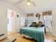Bright main bedroom featuring light wood floors, a ceiling fan, and decor at 8523 Hamster Dr, Zephyrhills, FL 33540