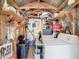 Interior view of a shed equipped with a washing machine, shelving, and many stored items at 8523 Hamster Dr, Zephyrhills, FL 33540