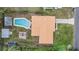 Aerial view of home with pool, fire pit, sheds, and backyard at 8724 N Renfrew Pl, Tampa, FL 33604