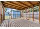 Screened porch with wood flooring and view of the shed and fenced backyard at 8724 N Renfrew Pl, Tampa, FL 33604