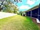 Lush backyard with mature trees and privacy wall at 9006 Callaway Dr, Trinity, FL 34655