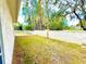 Lawn with privacy wall featuring a glimpse of the pond at 9006 Callaway Dr, Trinity, FL 34655