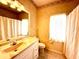 Bathroom features neutral decor, white vanity, and shower and tub with curtain at 9006 Callaway Dr, Trinity, FL 34655