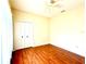 A bedroom with a ceiling fan, hardwood floors and a double door closet at 9006 Callaway Dr, Trinity, FL 34655