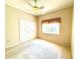Bedroom featuring neutral paint, ceiling fan, closet and window at 9006 Callaway Dr, Trinity, FL 34655