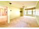 Bedroom featuring neutral paint, ceiling fan, carpet and windows for natural light at 9006 Callaway Dr, Trinity, FL 34655