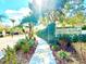 Gated community entrance with lush landscaping, secure access, and decorative sign at 9006 Callaway Dr, Trinity, FL 34655