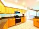 Well-equipped kitchen featuring stainless steel appliances, granite countertops, and ample cabinet space at 9006 Callaway Dr, Trinity, FL 34655