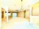 Open-concept living area with neutral tones, large window, and seamless flow to other rooms at 9006 Callaway Dr, Trinity, FL 34655