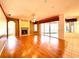Bright living room featuring hardwood floors, fireplace, ceiling fan and sliding glass doors to the lanai at 9006 Callaway Dr, Trinity, FL 34655
