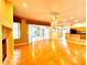 Open-concept living room boasts hardwood floors, a fireplace, and sliding door access to the porch at 9006 Callaway Dr, Trinity, FL 34655