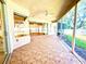 Screened in patio with tiled floor, fan, and ample space for entertaining at 9006 Callaway Dr, Trinity, FL 34655