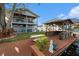 Waterfront backyard featuring a private dock, covered bar, hot tub, and lush lawn, ideal for outdoor living at 9920 Alavista Dr, Gibsonton, FL 33534