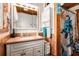 Bathroom features wood paneling, sink vanity, and a shower with a turtle themed shower curtain at 9920 Alavista Dr, Gibsonton, FL 33534