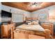 The cozy bedroom features wooden ceiling, a queen-sized bed with nautical-themed decor, and plenty of natural light at 9920 Alavista Dr, Gibsonton, FL 33534