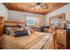 The bedroom features wooden ceiling, a queen-sized bed with nautical-themed decor, and classic wooden furniture at 9920 Alavista Dr, Gibsonton, FL 33534