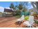 Outdoor deck with lounge chairs, lush landscaping, and covered bar area, perfect for relaxation at 9920 Alavista Dr, Gibsonton, FL 33534