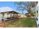 Waterfront property featuring a private dock with covered boat lift and bar area for relaxing by the water at 9920 Alavista Dr, Gibsonton, FL 33534