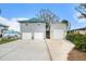 Charming waterfront home featuring a two-car garage and a separate garage with a carport at 9920 Alavista Dr, Gibsonton, FL 33534
