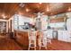 The bright kitchen features a large island with seating, stainless steel appliances, and wood accents, offering a stylish cooking space at 9920 Alavista Dr, Gibsonton, FL 33534