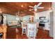 The open floor plan combines the living room and kitchen, creating a unified and inviting space with wood ceiling and floors at 9920 Alavista Dr, Gibsonton, FL 33534