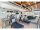 Lounge chairs and dining area on a covered deck, providing a serene waterfront retreat at 9920 Alavista Dr, Gibsonton, FL 33534